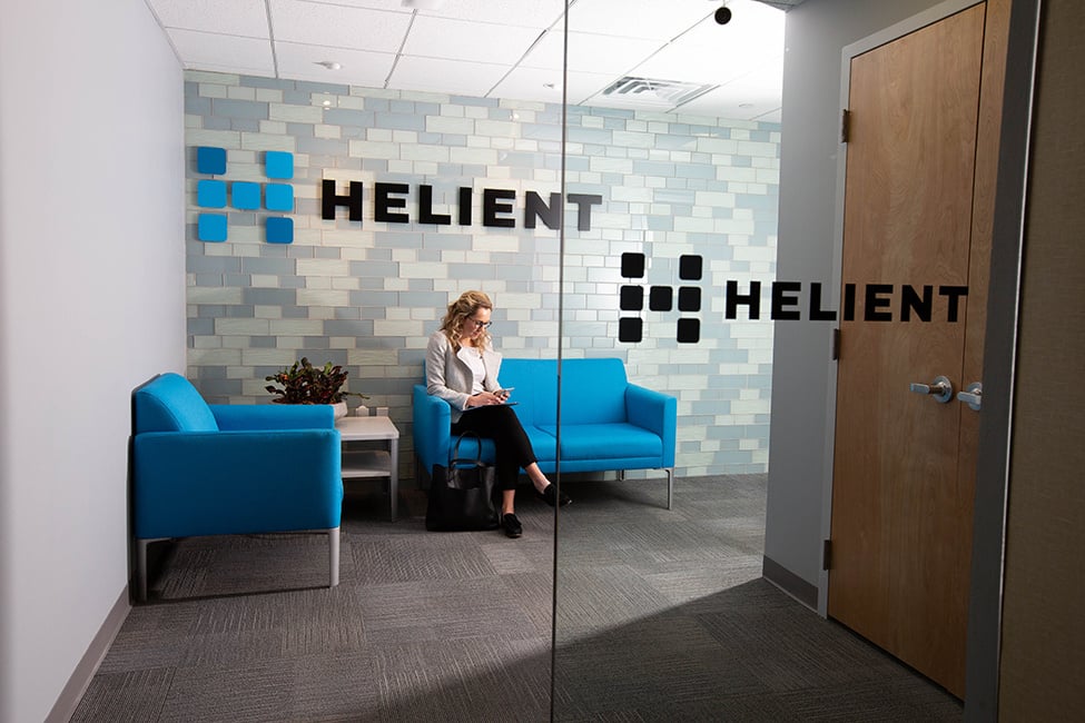 Woman sitting in on a couch in a Helient office